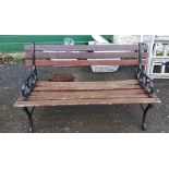 A 1.22m garden bench with slatted wooden back and seat, set on cast iron scroll ends