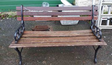 A 1.22m garden bench with slatted wooden back and seat, set on cast iron scroll ends