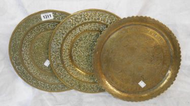 Two Indian embossed brass trays - sold with a similar chased tazza