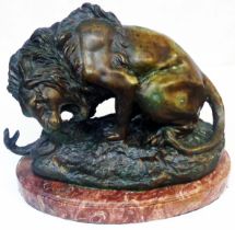 A mid 20th Century bronze figurine depicting a lion fighting a serpent, set on red marble base