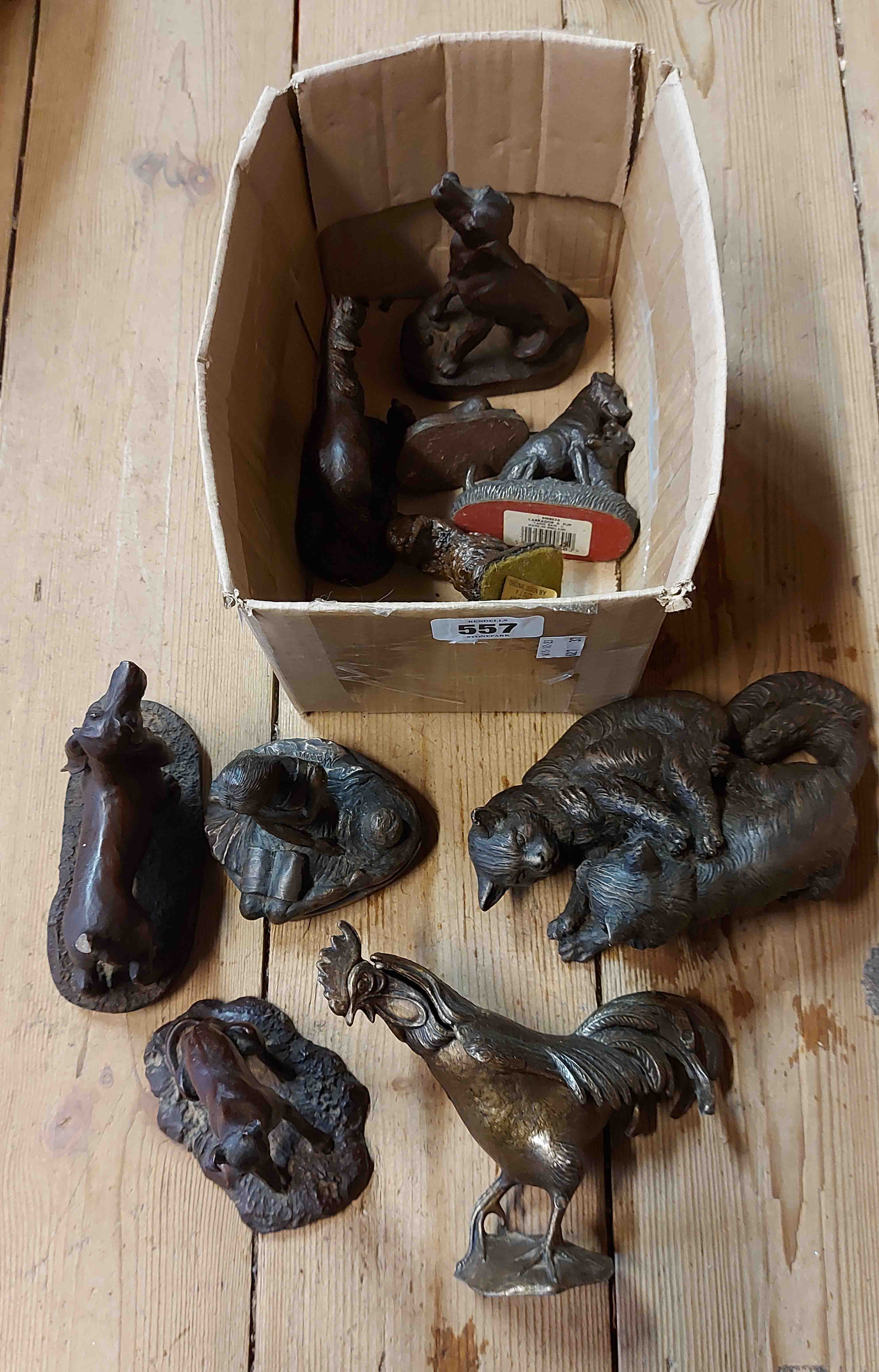 A box containing a quantity of resin and metal animal figurines