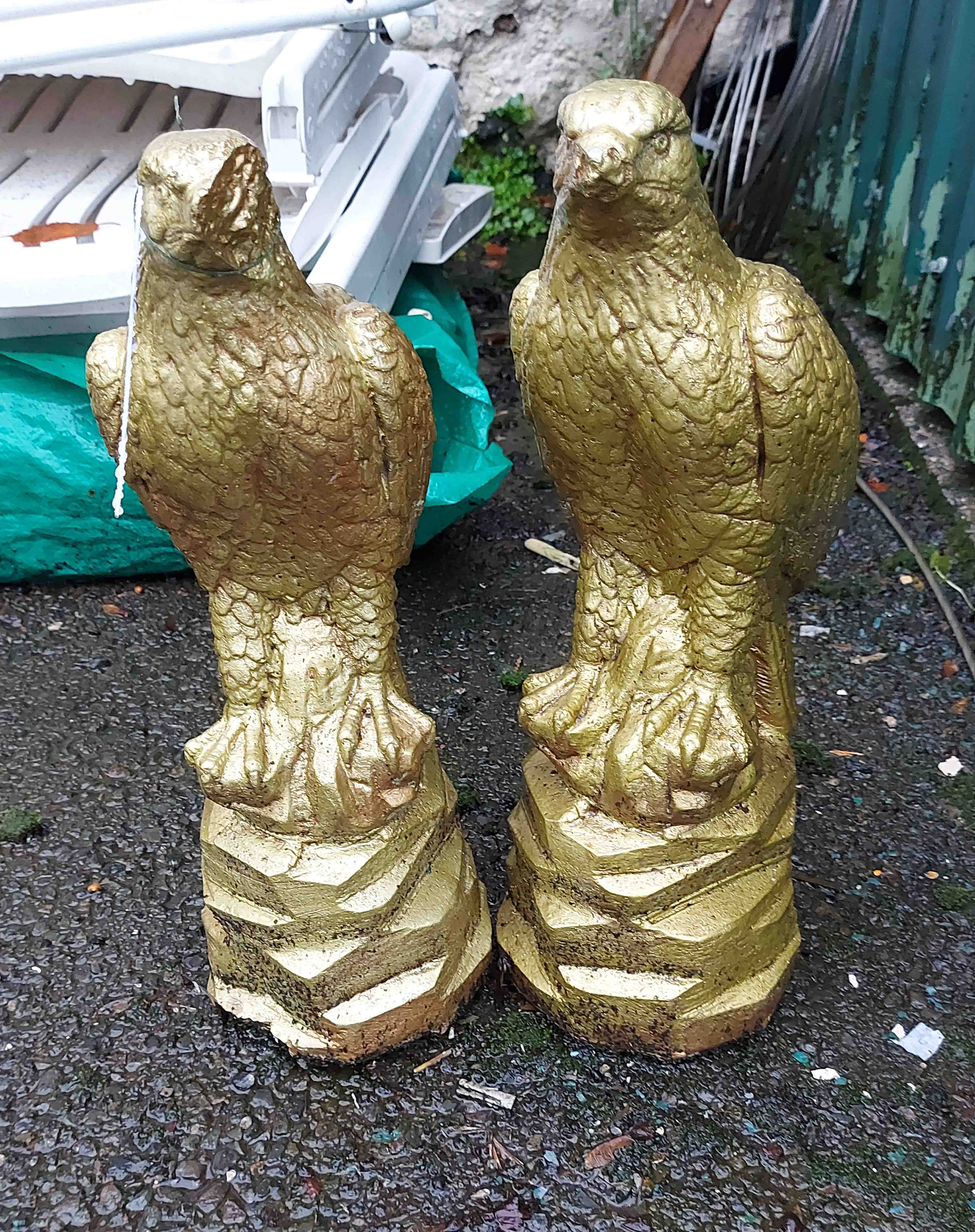 A pair of 45cm high cast concrete eagle statuettes with gilt finish