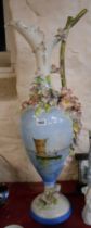 A very large Italian pottery jug of ewer form with applied flowers and hand painted decoration