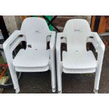 A set of four modern plastic garden elbow chairs