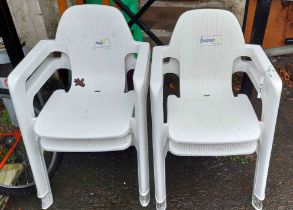 A set of four modern plastic garden elbow chairs