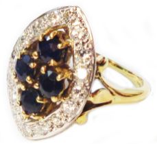 A 750 (18ct.) gold marquise panel ring, set with four central sapphires within a diamond encrusted