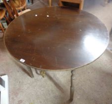A 1.05m diameter vintage oak table, set on turned legs