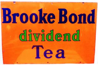 An original 'Brooke Bond Dividend Tea' enamel advertising sign with blue and green lettering on an