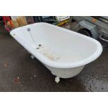A large vintage white painted cast iron bath