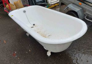 A large vintage white painted cast iron bath