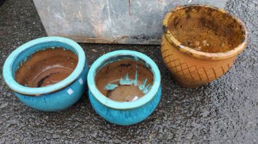A pair of blue glazed garden pots and a terracotta similar