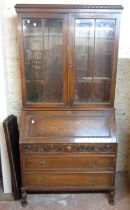 A 1.02m early 20th Century stained oak bureau/bookcase with moulded cornice, adjustable shelves