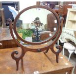 An Edwardian swing dressing table mirror with inlaid border to the oval plate, set on swept
