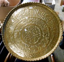 A large Eastern brass tray with embossed decoration