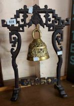 A Chinese cast brass bell, set on carved hardwood stand