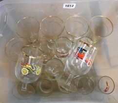 A crate containing a quantity of vintage glassware with printed veteran car decoration