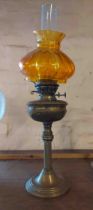 A brass oil lamp of column form, with chimney and painted amber shade - a/f