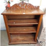 A 96cm Victorian mahogany three shelf open bookcase with decorative carved raised back, set on