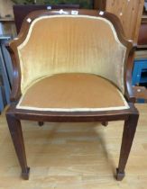 An Edwardian mahogany part show frame tub elbow chair with piped gold velour upholstery, set on