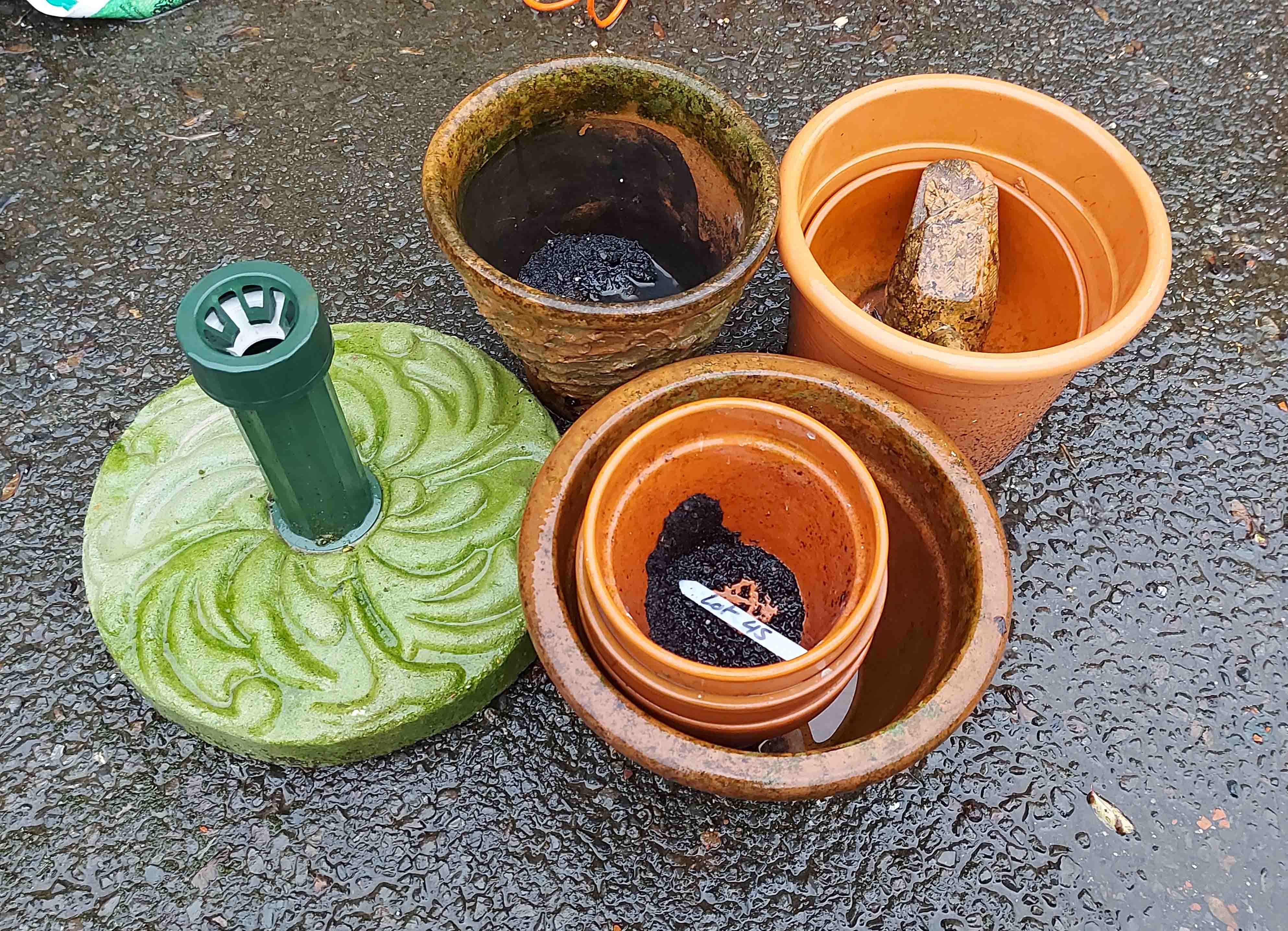 A quantity of assorted terracotta plant pots and a model of a duck- sold with a parasol base