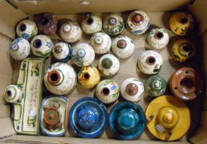 A box containing a large quantity of Torquay pottery inkwells and desk stands of various size and