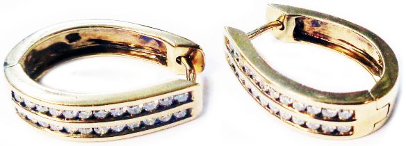 A pair of marked 9k yellow metal clasp pattern hoop earrings, each set with two rows of small