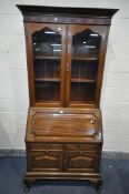 A MAHOGANY BUREAU BOOKCASE, with an overhanging cornice, the top with a blind fretwork detail, above