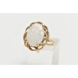 A 9CT GOLD RING, designed with a four claw set, oval synthetic opal cabochon, within an openwork