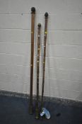 TWO BAMBOO CURTAIN POLES, max length 182cm, and a beech curtain rail (condition:-distressed brass