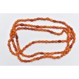 A NATURAL AMBER BEAD NECKLACE, one hundred and forty three amber beads, oval form, slightly