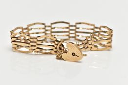 A 9CT YELLOW GOLD GATE BRACELET, four bar bracelet, fitted with a heart padlock clasp, with