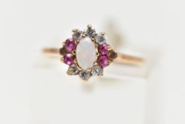 A 9CT YELLOW GOLD CLUSTER RING, centering on an oval opal cabochon, in a surround of six