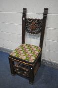 A 19TH CENTURY JACOBEAN STYLE CARVED OAK HALL CHAIR, the twin supports flanking an open foliate back