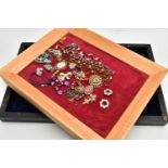 THREE WOODEN DISPLAY TRAYS AND COSTUME JEWELLERY, to include a black rectangular tray with a navy