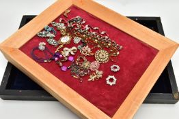THREE WOODEN DISPLAY TRAYS AND COSTUME JEWELLERY, to include a black rectangular tray with a navy