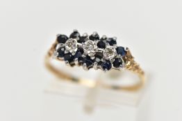A 9CT YELLOW GOLD DIAMOND AND SAPPHIRE DRESS RING, set with three diamond accents, surrounded by