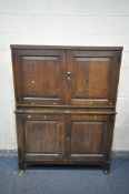 A LATE 19TH/EARLY 20TH CENTURY OAK CUPBOARD, with four fielded panel doors, on block legs, and front