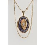 A 14CT GOLD ENAMEL AND DIAMOND SET LOCKET PENDANT AND CHAIN, the locket of an oval form, decorated