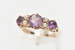 A YELLOW METAL GEM SET RING, designed with three circular cut amethysts, each interspaced with