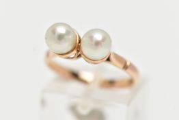 A YELLOW METAL CULTURED PEARL RING, designed with two white cultured pearls, measuring approximately