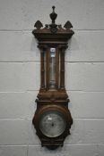 A LATE VICTORIAN OAK ANEROID BAROMETER, with a spiralling mercury thermometer, height 107cm (