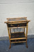 A BAMBOO SIDE TABLE, with ebonised and floral design, with hinged lid, and an undershelf with a