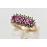 A 9CT YELLOW GOLD RUBY AND DIAMOND CLUSTER RING, the cluster of an oval form, to the center is