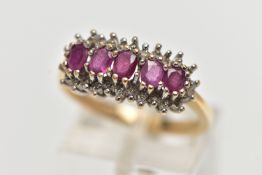 A 9CT YELLOW GOLD RUBY AND DIAMOND CLUSTER RING, the cluster of an oval form, to the center is