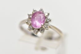 AN 18CT WHITE GOLD PINK SAPPHIRE AND DIAMOND CLUSTER RING, centering on a four claw set, oval cut