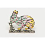 A WHITE METAL PLIQUE A JOUR BROOCH, in the form of a rabbit, set with a red cabochon eye,