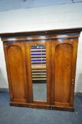 A VICTORIAN FLAME MAHOGANY COMPACTUM WARDROBE, with triple doors, enclosing two compartments, the