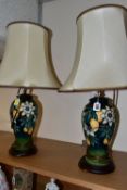 A PAIR OF MOORCROFT POTTERY 'PASSION FLOWER' TABLE LAMPS, of baluster form, with tube lined