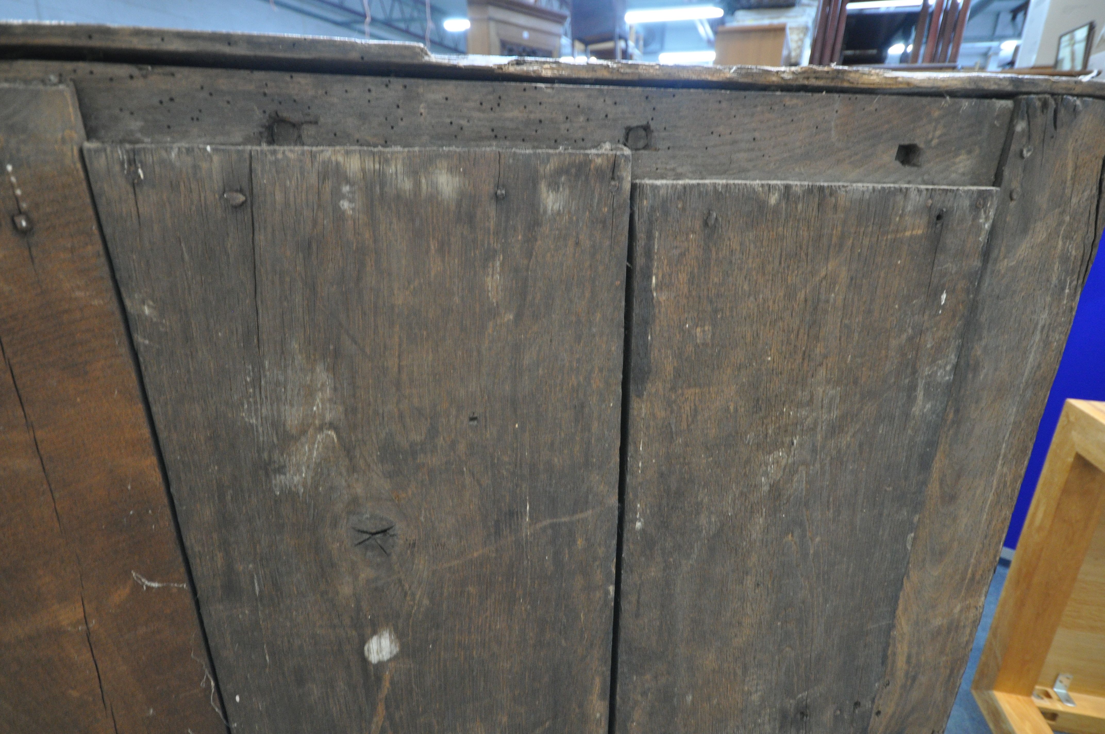 A 17TH CENTURY JOINED OAK CUPBOARD, with a carved top rail, and initialled I.H.E, the double doors - Image 8 of 9