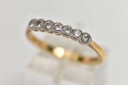 AN 18CT GOLD SEVEN STONE DIAMOND RING, a row of collet set round brilliant cut diamonds, estimated